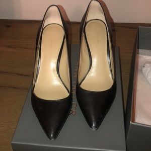 Worn black leather heels. Needs to be polished